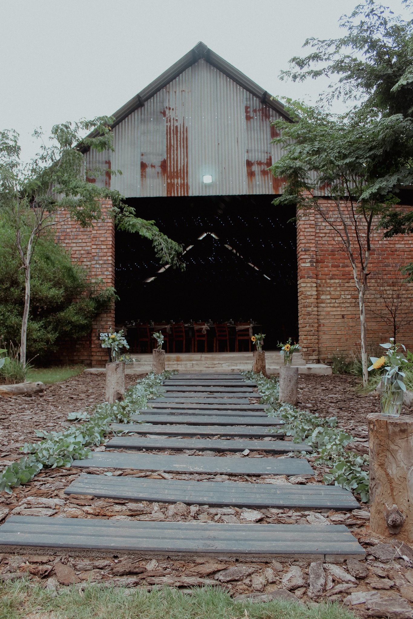 Decorated stepping-stone path leading to the rustic reception venue.