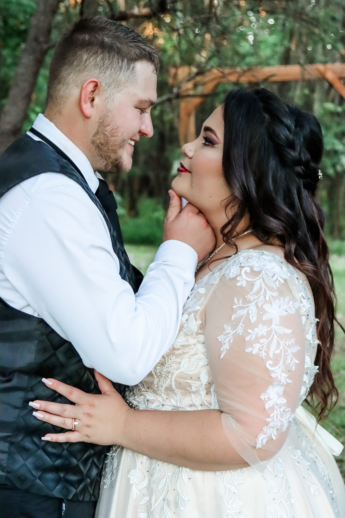 Wedding couple sharing a close moment in the garden.